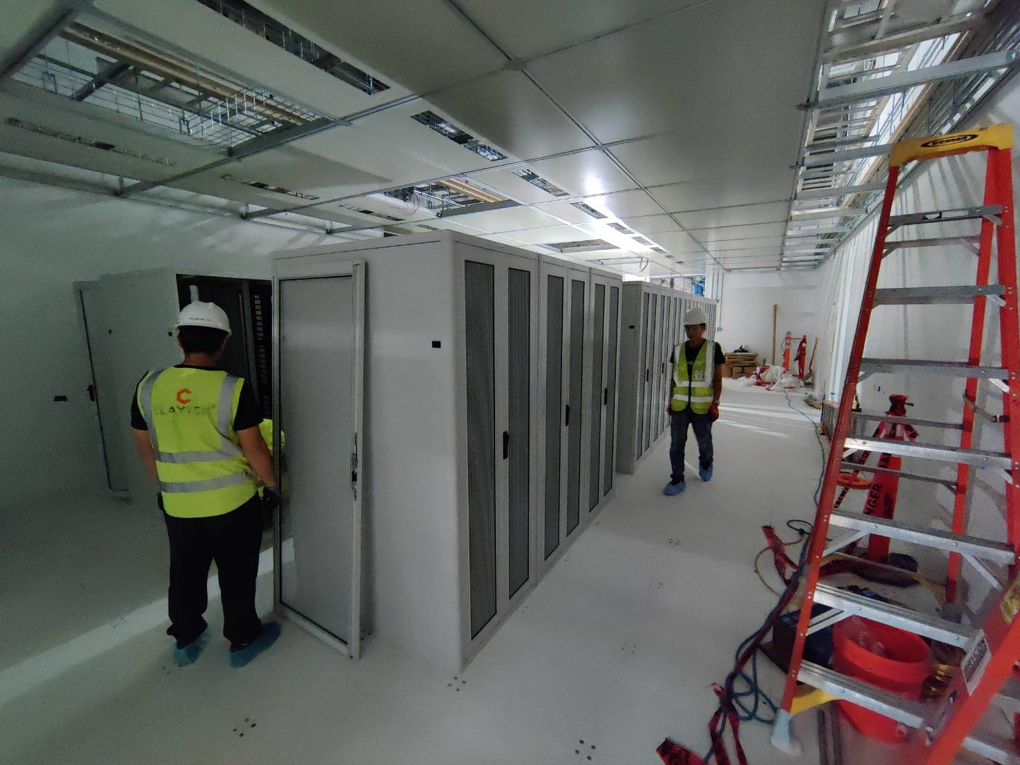 Technicians installing a row of server cabinets