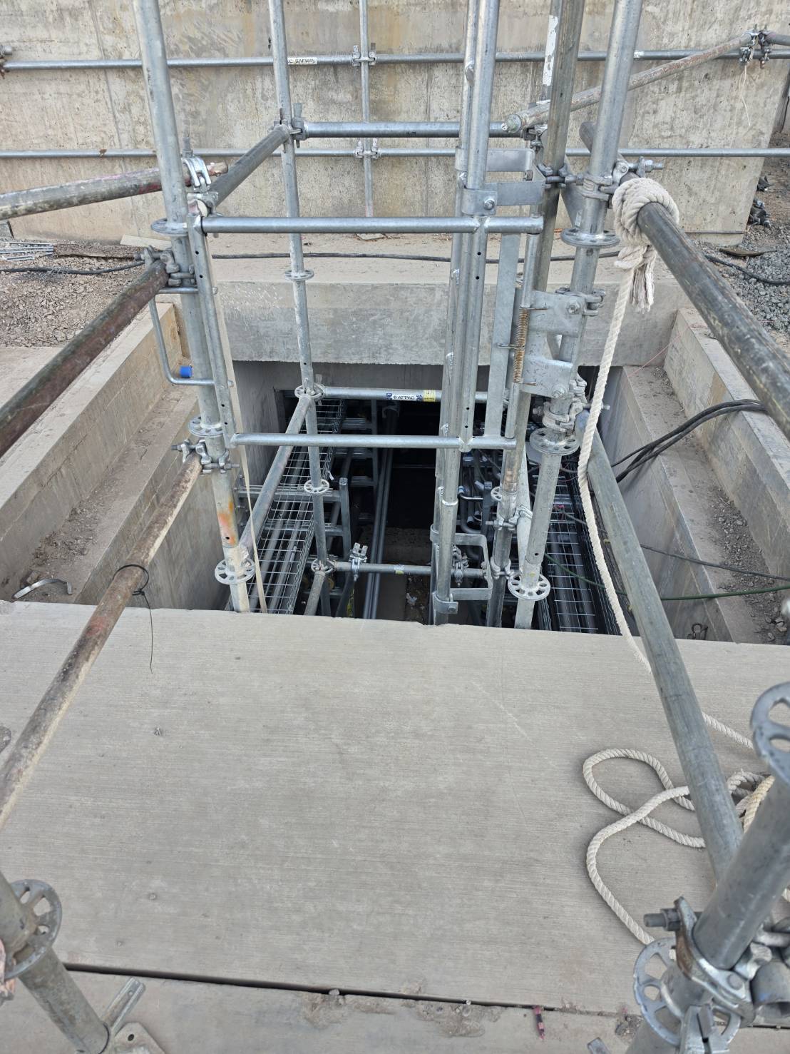 Access down into an underground pathway vault from scaffolding