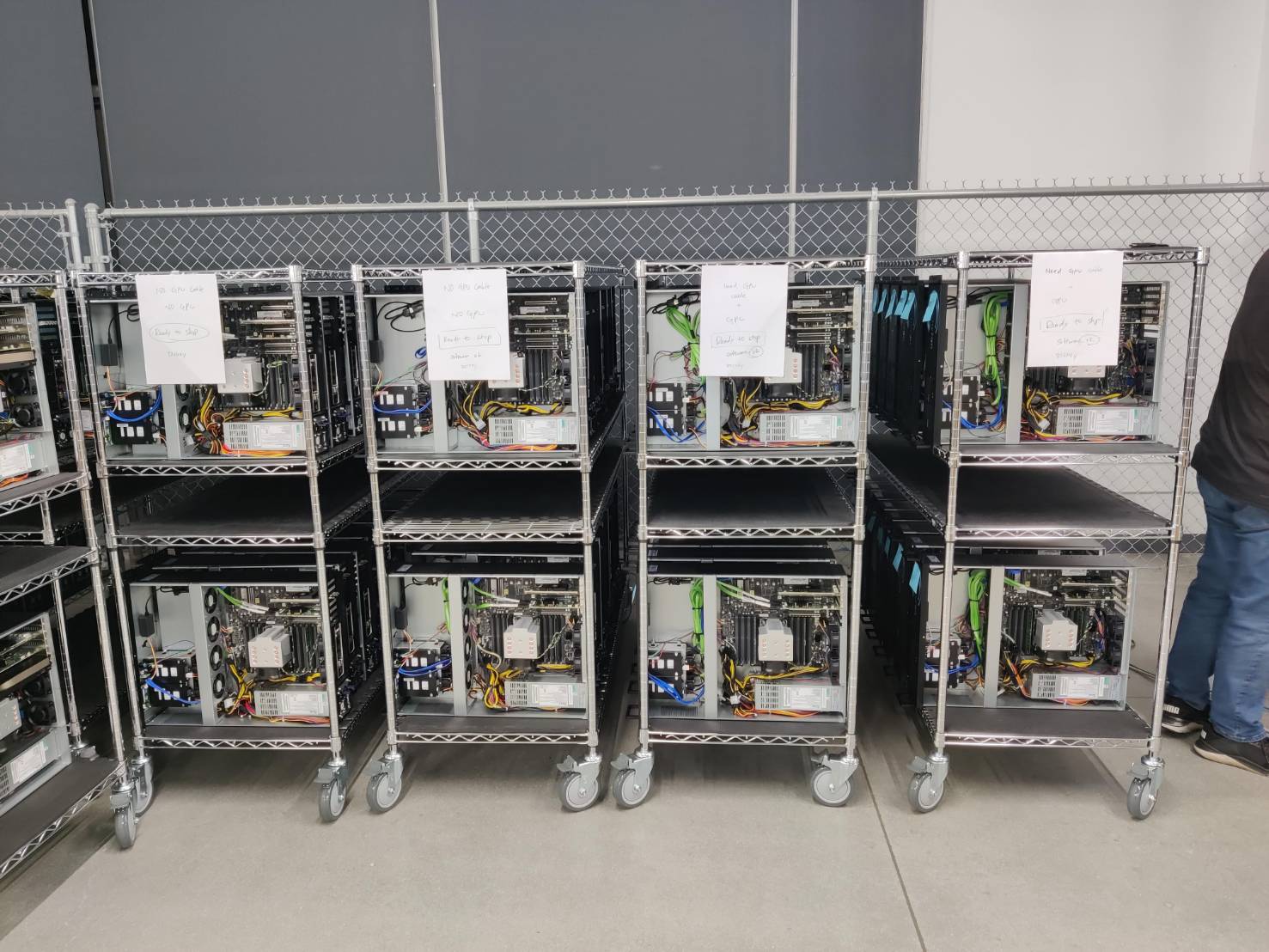 GPU systems on carts marked ready to ship after assembly and inspection