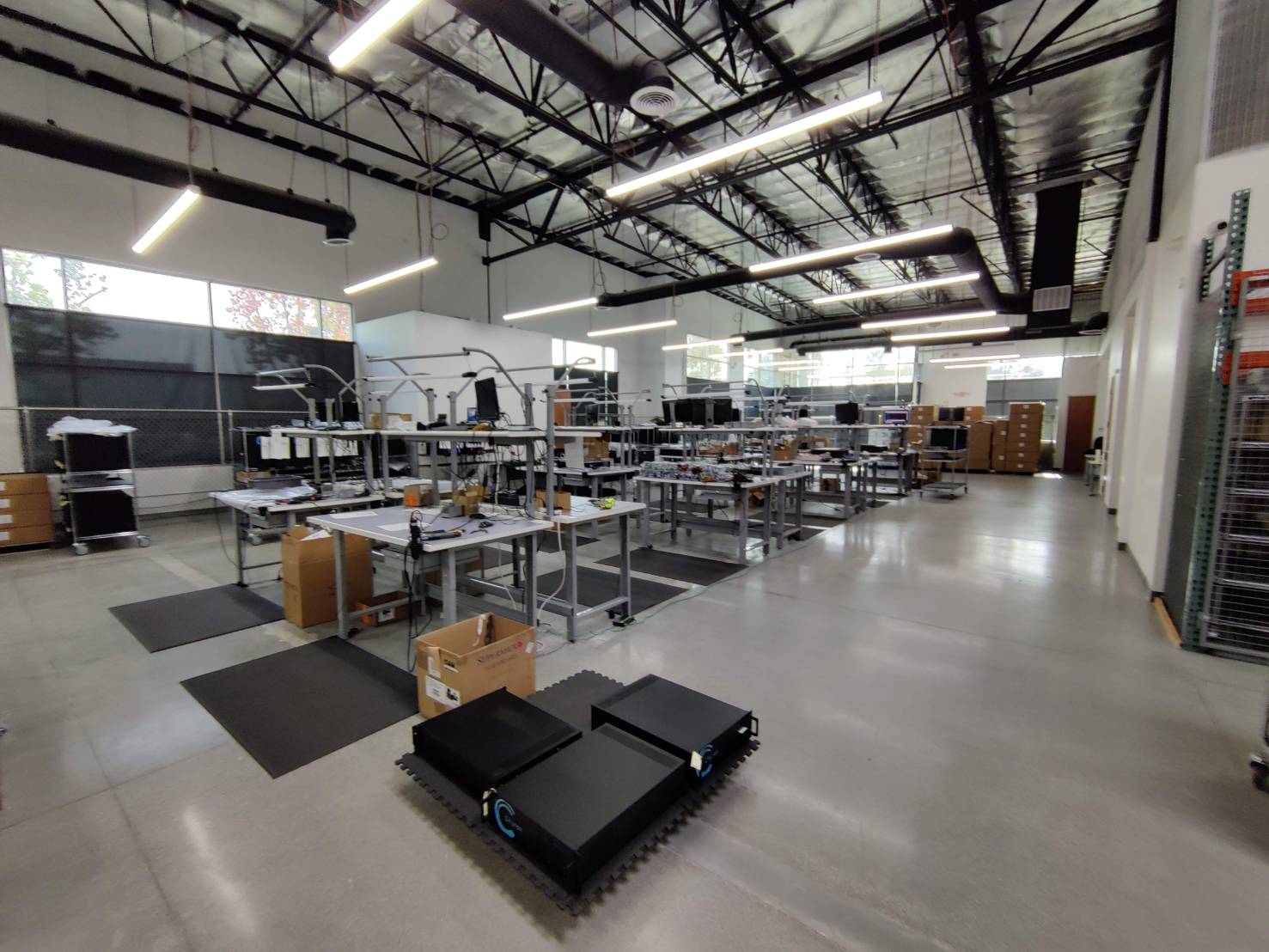 Integration floor with chassis on the line and finished systems staged for packing